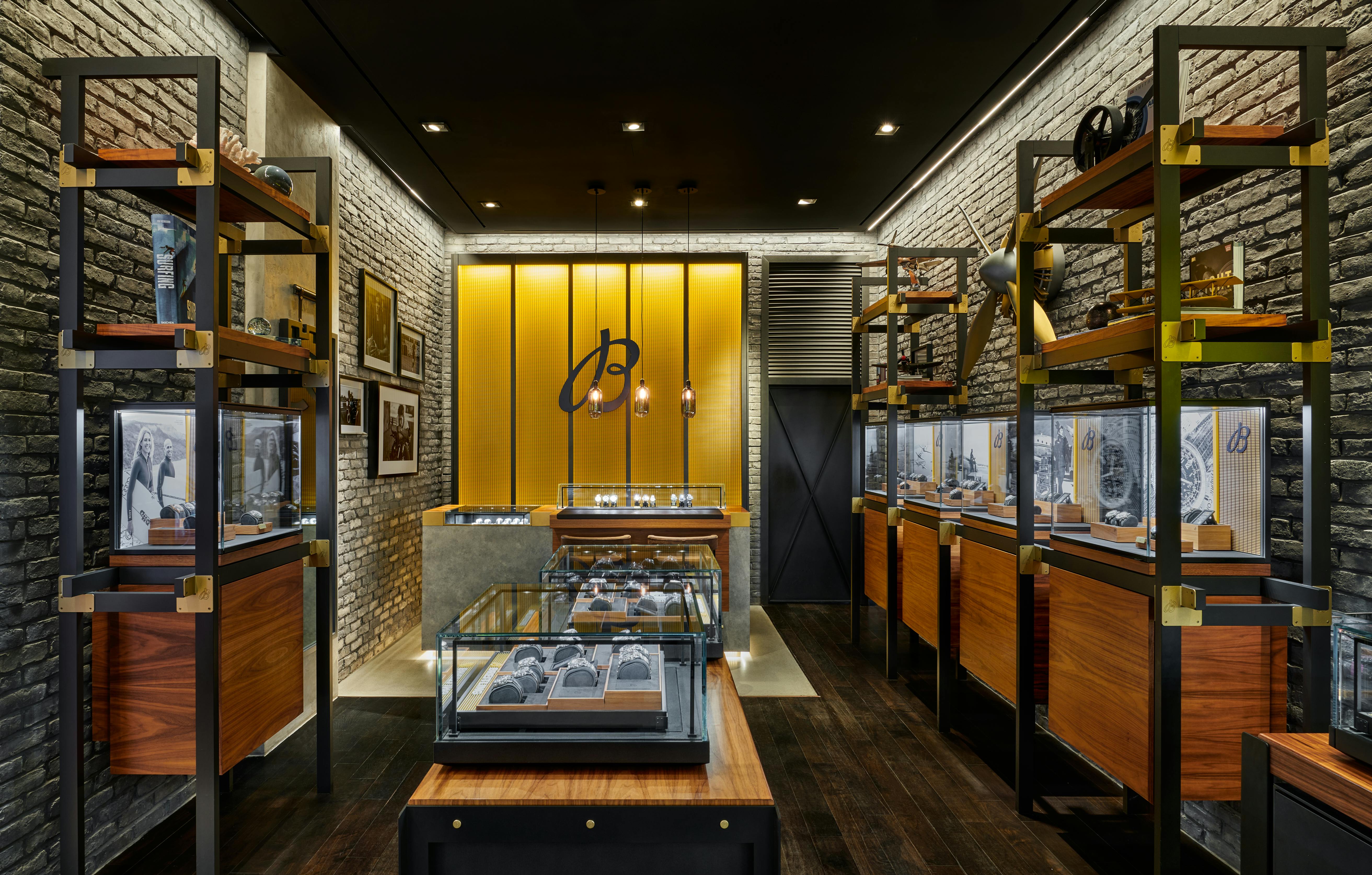 Breitling boutique interior showcasing central watch display table and wood-accented cabinetry