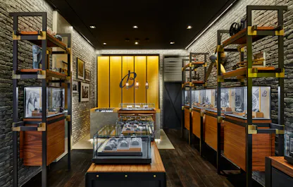 Breitling boutique interior showcasing central watch display table and wood-accented cabinetry