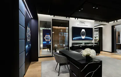 Private client lounge inside IWC Schaffhausen Denver boutique featuring watch movement artwork